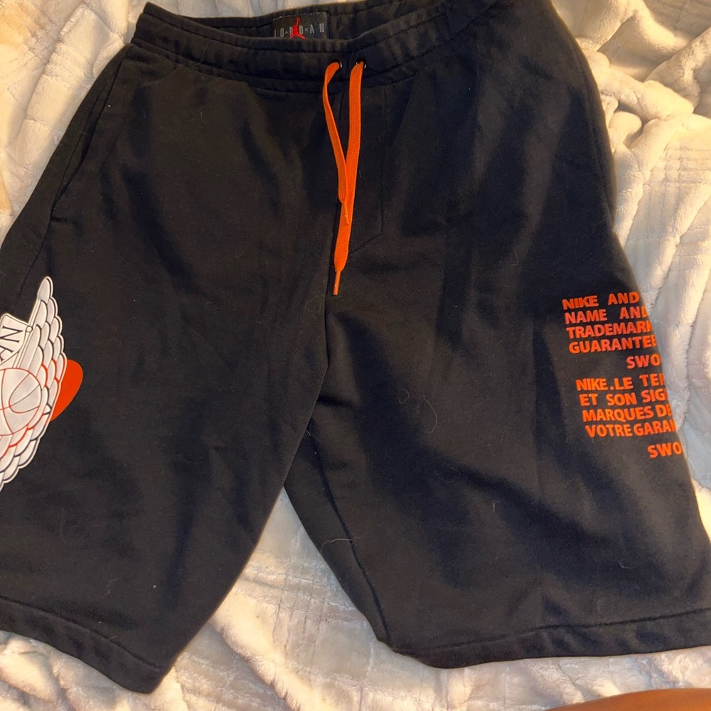 Jordan shorts in the color black with orange detailing in size medium